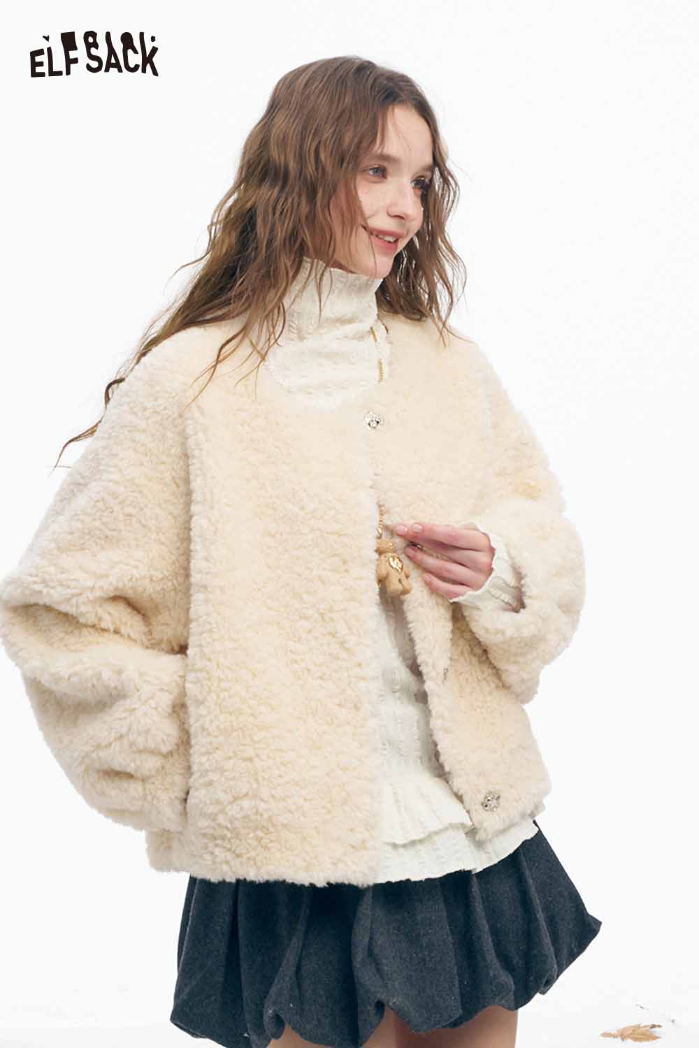 ELFSACK women's ruffle high neck t-shirt layered under a cozy cream jacket with a stylish skirt