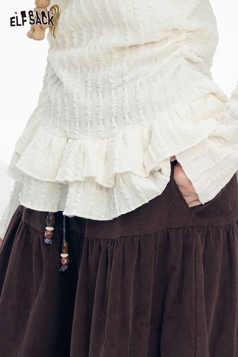 Women's ruffle high neck t-shirt in cream color with textured fabric and layered hem detail