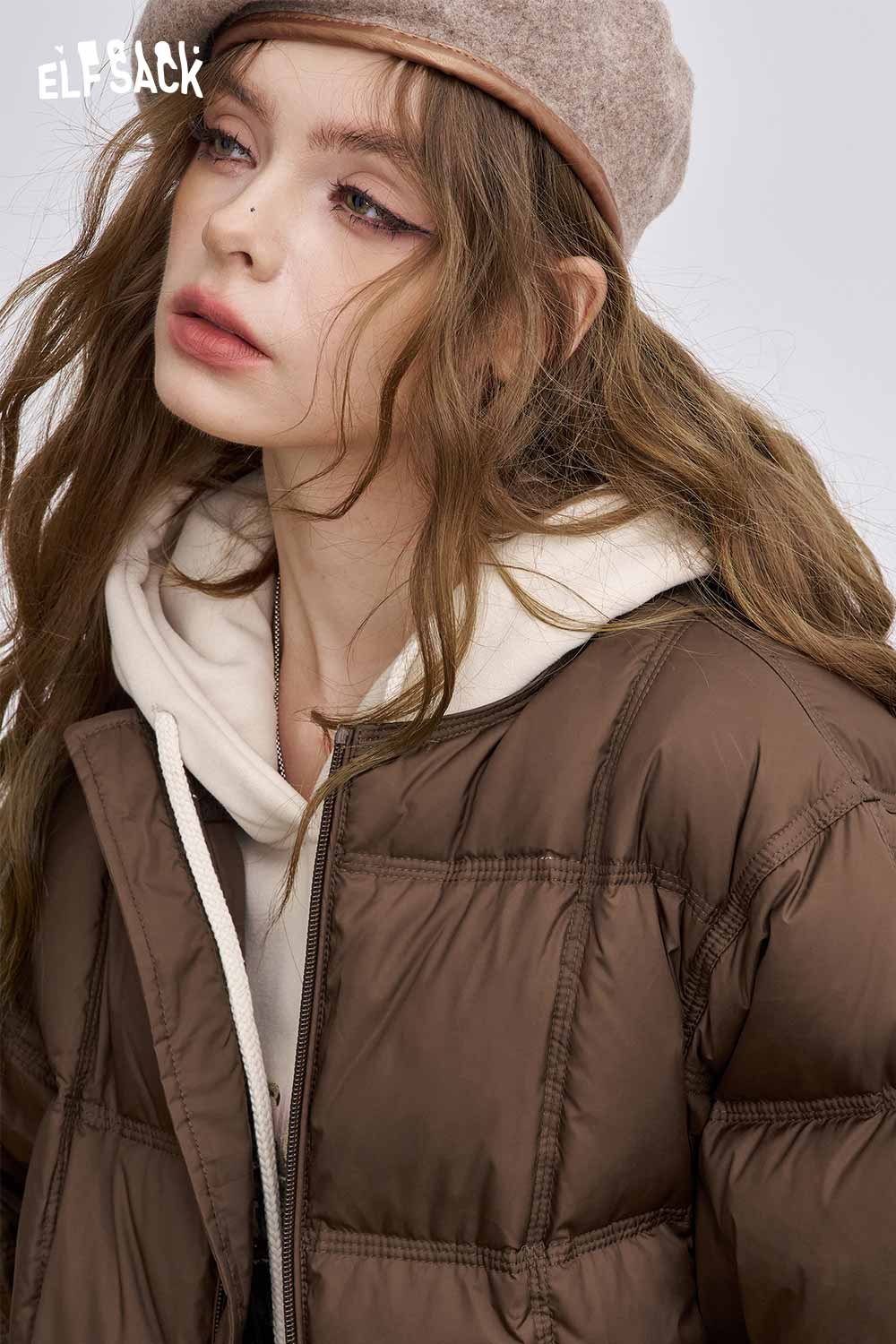 ELFSACK women's soft down jacket in brown, stylishly paired with a cozy hoodie and cap