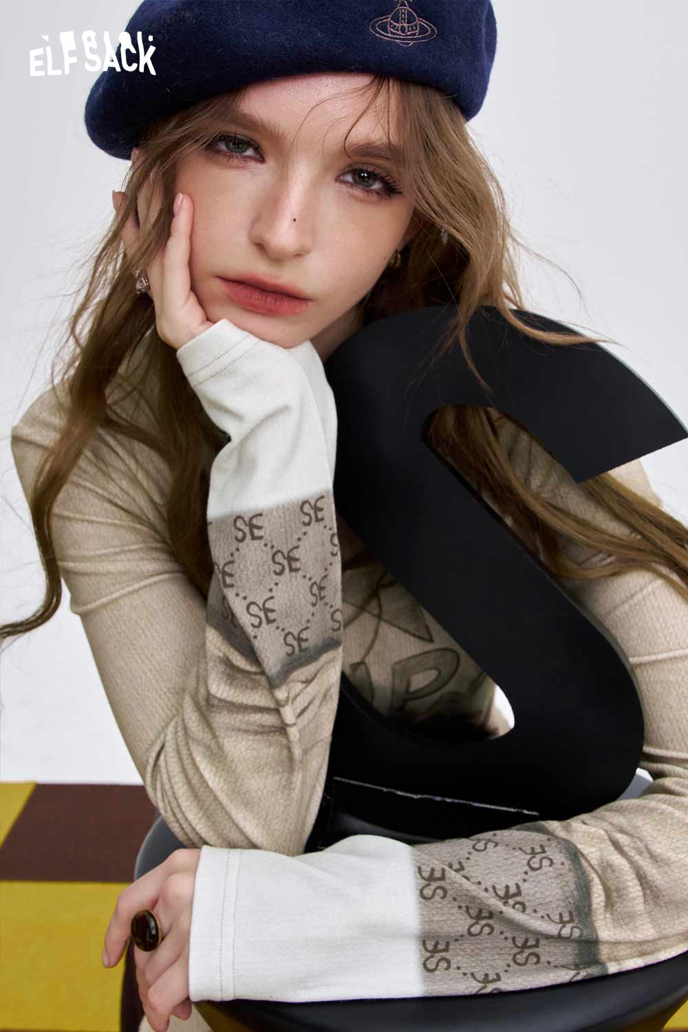 ELFSACK women's soft graphic long sleeve t-shirt in cream with unique letter design and stylish sleeves