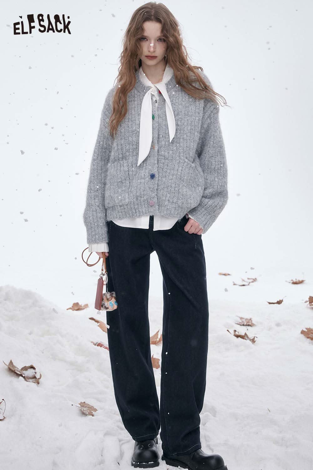 ELFSACK women's straight leg jeans styled with a cozy sweater in a snowy outdoor setting