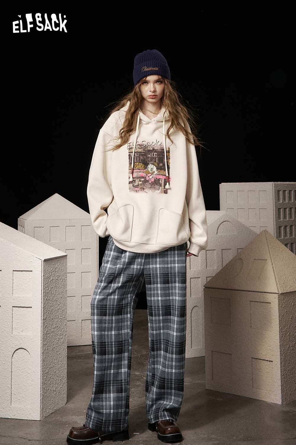 Model wearing ELFSACK women's striped drawstring pants paired with a cozy hoodie for a stylish look
