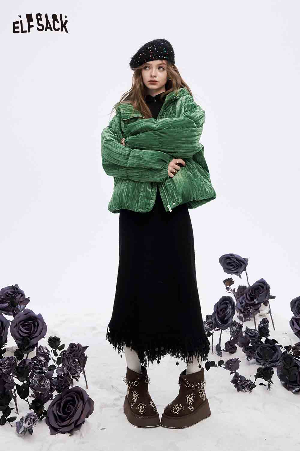 ELFSACK women's velvet puffer coat in green, styled with a black dress and beret among flowers