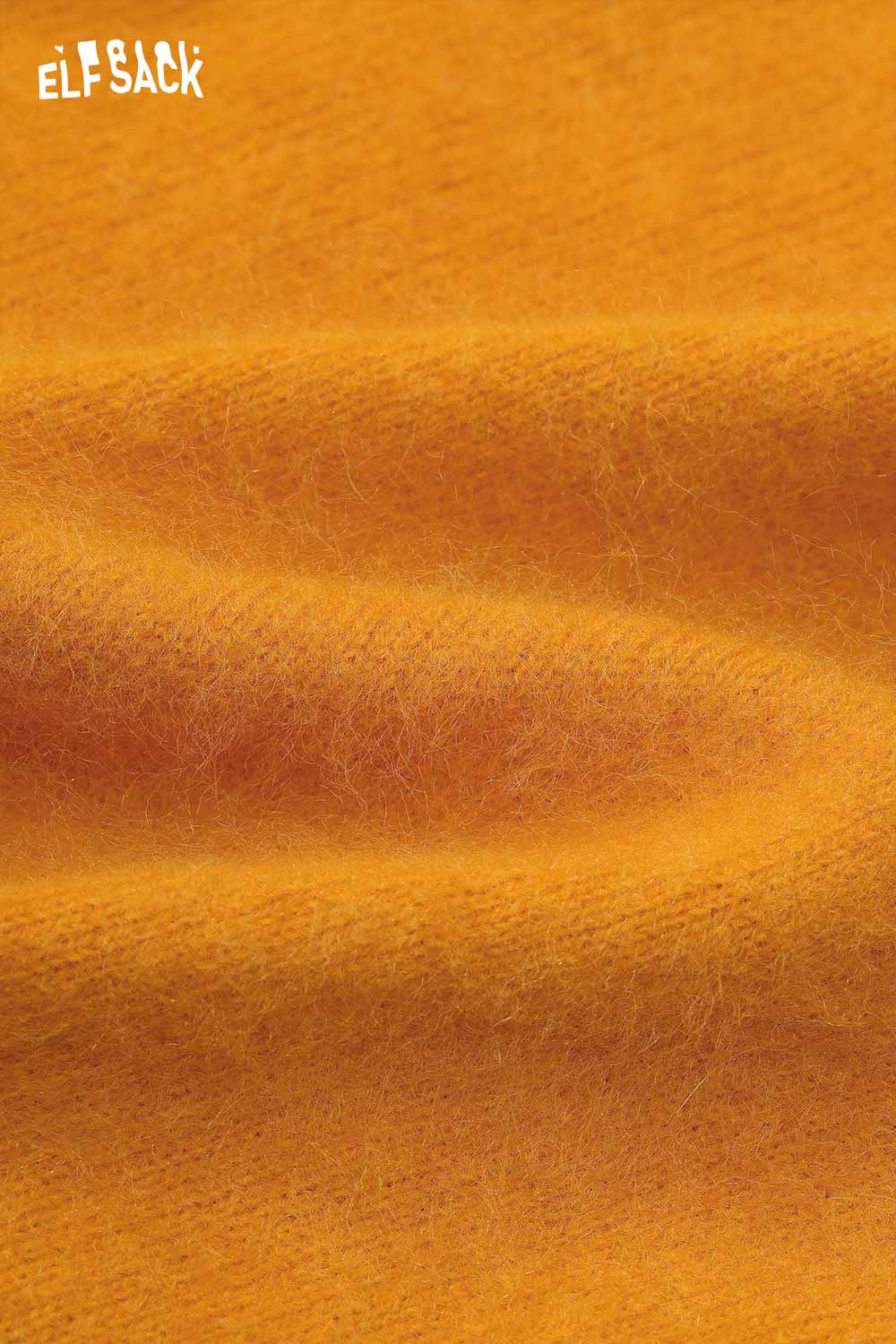 Close-up of soft texture of ELFSACK wool blend oversized sweater women in vibrant yellow color