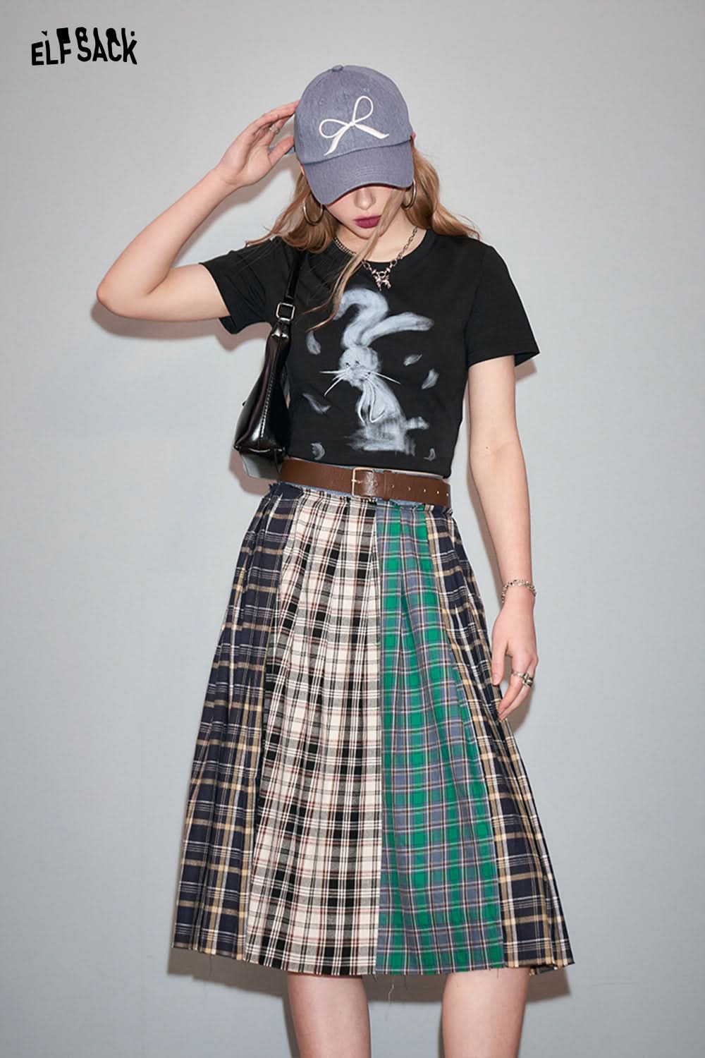 ELFSACK black T-shirt with Y2K Rabbit Print paired with a multicolor plaid skirt and gray cap
