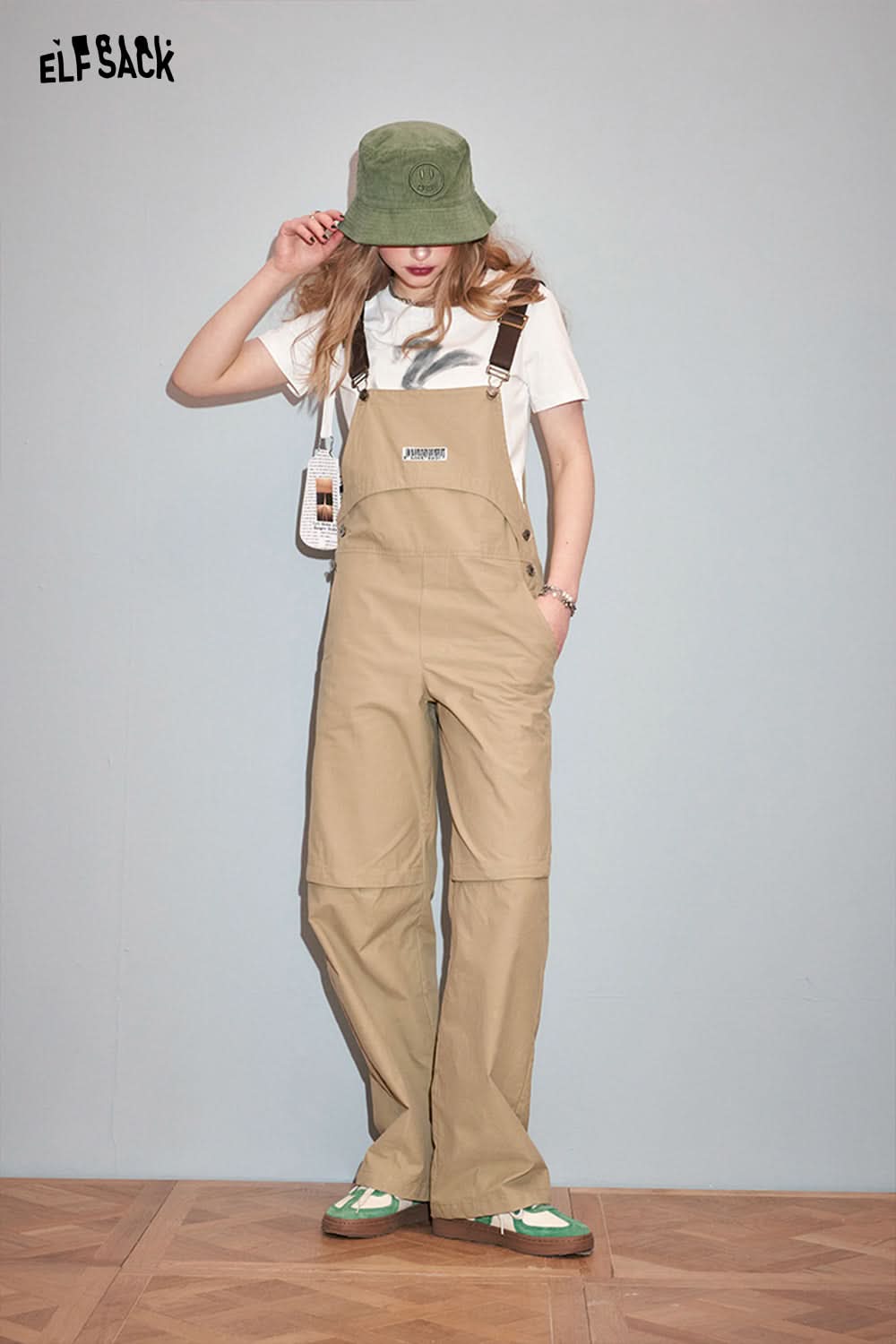ELFSACK casual outfit featuring Y2K Rabbit Print t-shirt paired with beige overalls and green bucket hat
