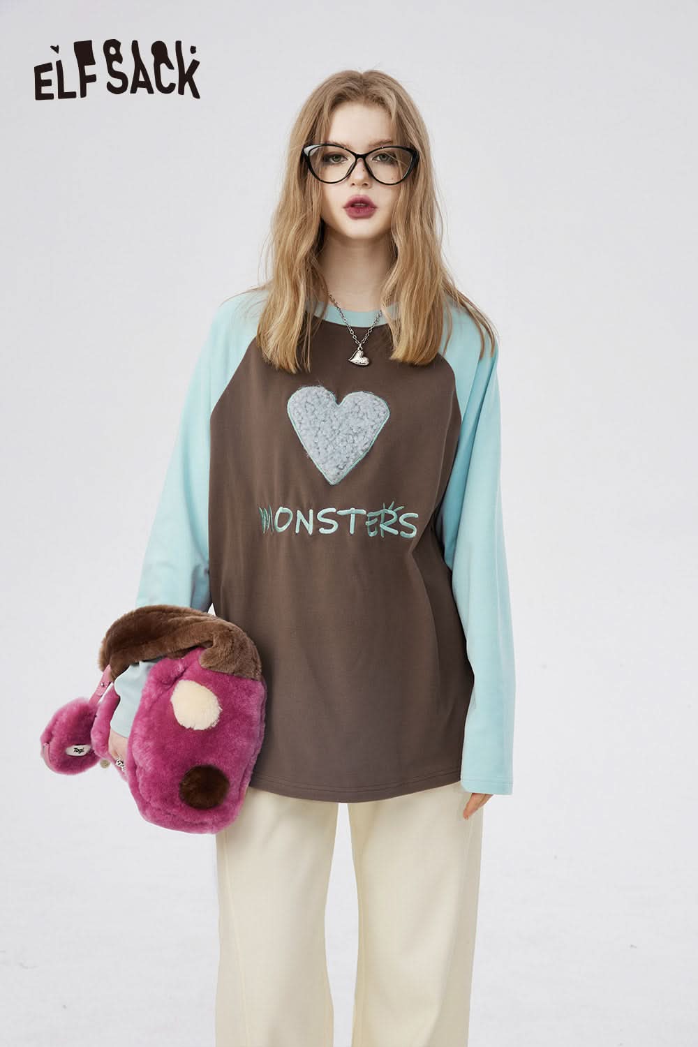 ELFSACK women's casual long sleeve t-shirt with brown body and light blue sleeves featuring heart and monsters print