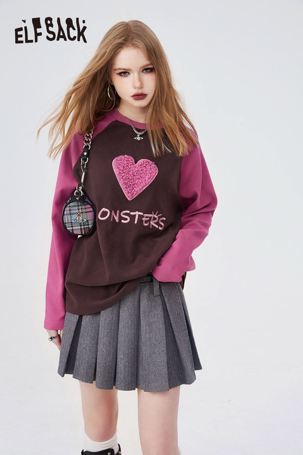 ELFSACK Long Sleeve T-shirt with pink sleeves and heart graphic worn with gray pleated skirt