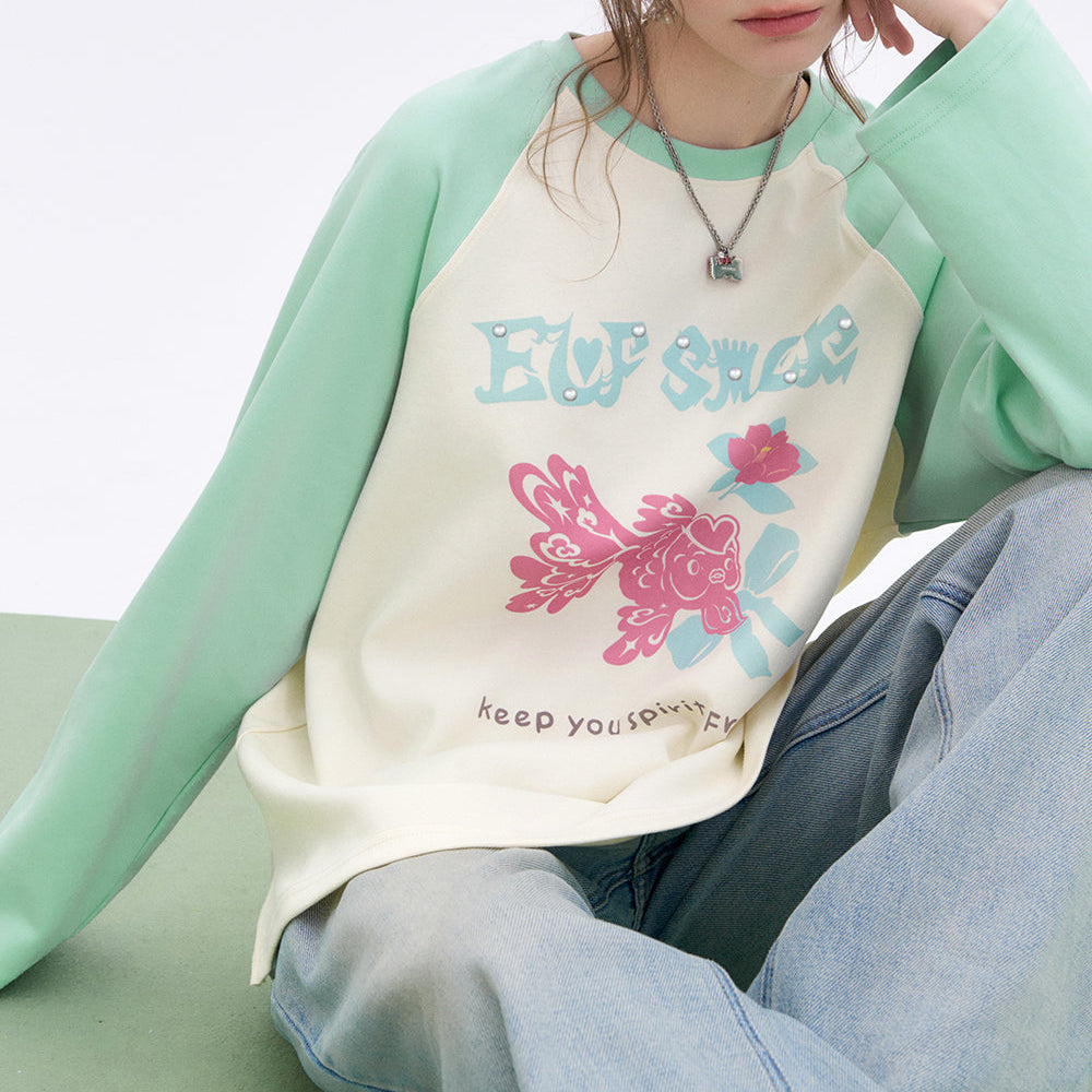 
                  
                    ELFSACK 2025 Spring New Arrivals Lucky Goldfish Printed Raglan Long Sleeve T-shirt Women Basic Casual Round Neck Korean Top
                  
                