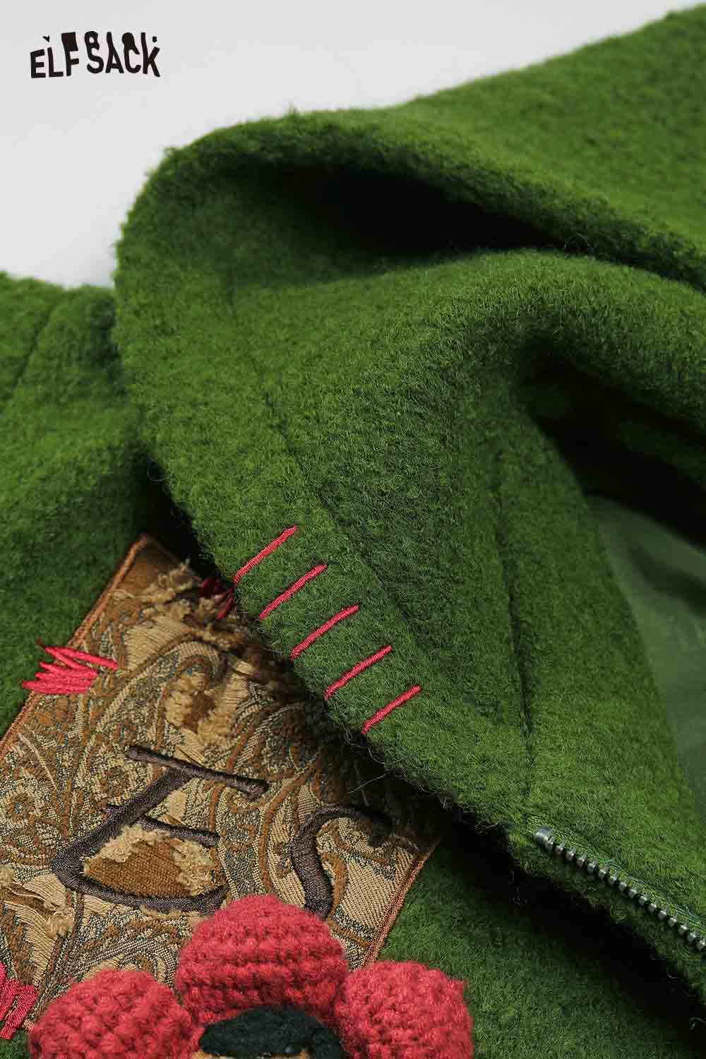 Detail of ELFSACK 3D embellished hooded coat for women showing intricate embroidery and textured fabric