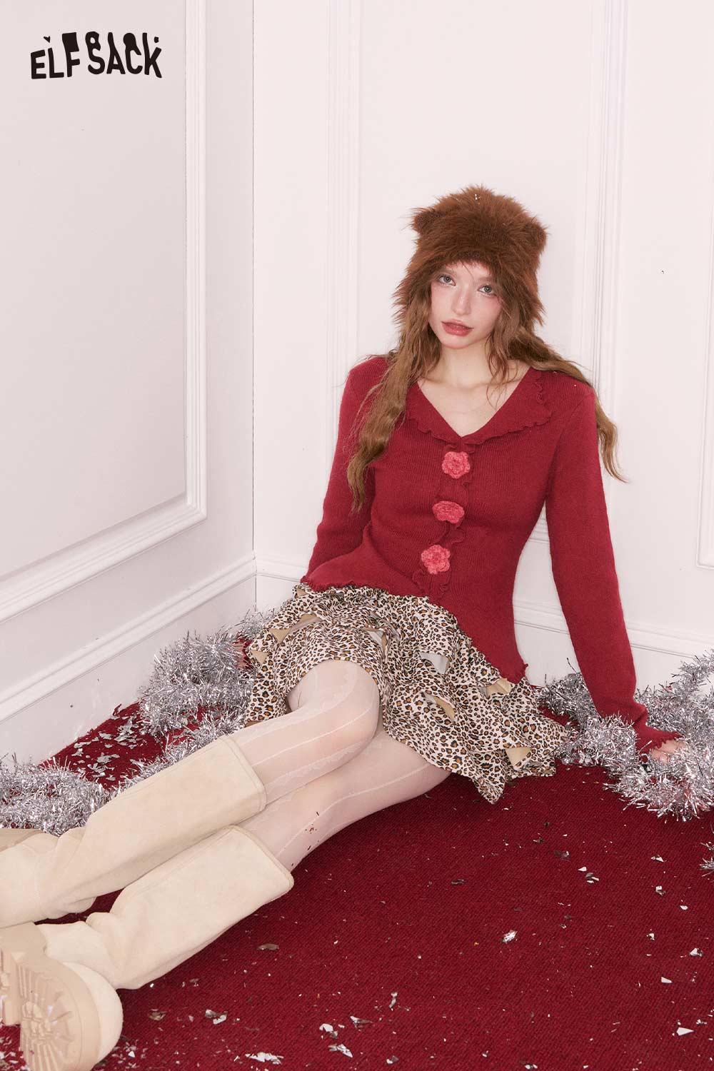 ELFSACK 3D flower knitwear for women, styled with a stylish skirt and winter accessories.