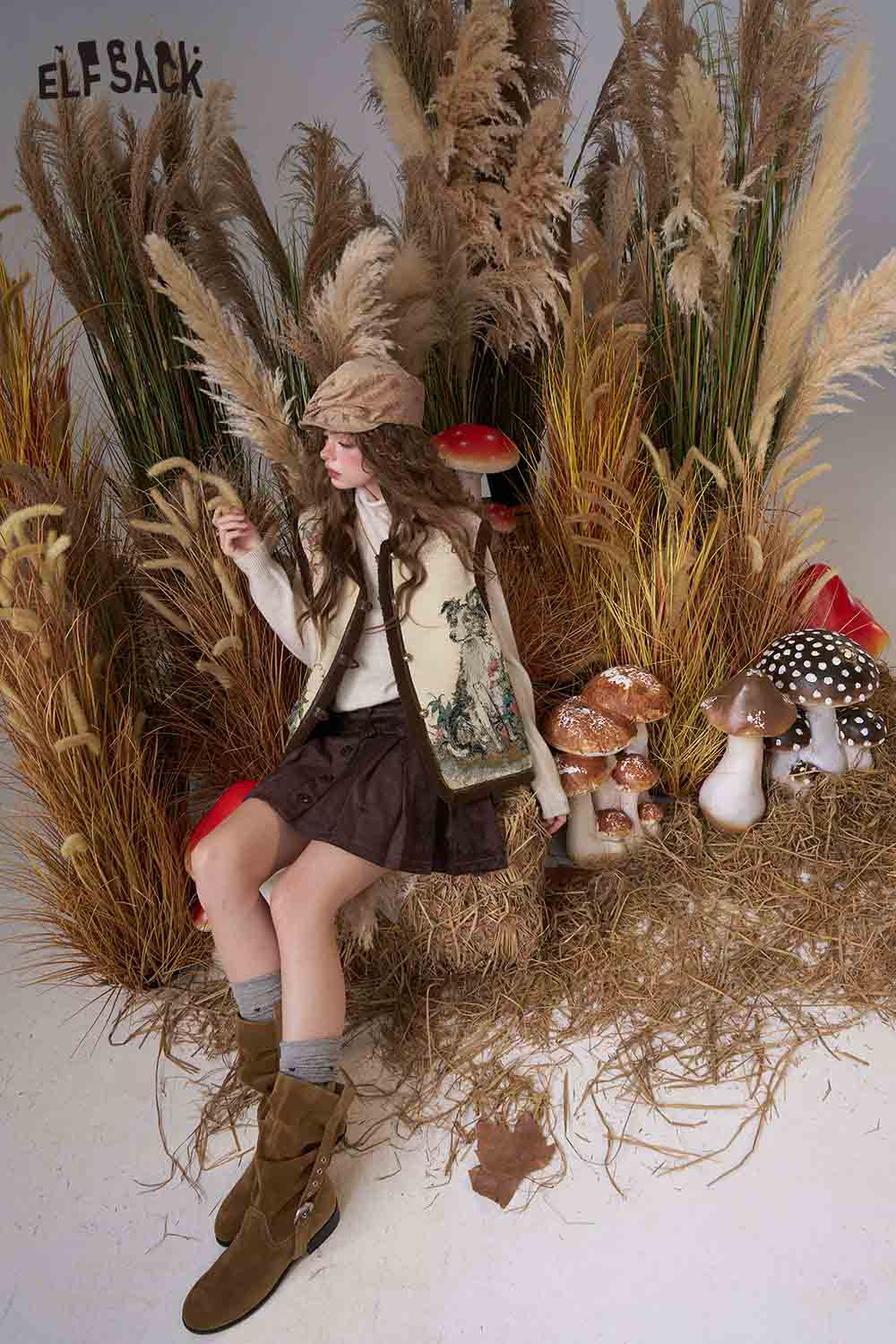 ELFSACK animal embroidery knit vest styled with a brown skirt and autumn-themed backdrop