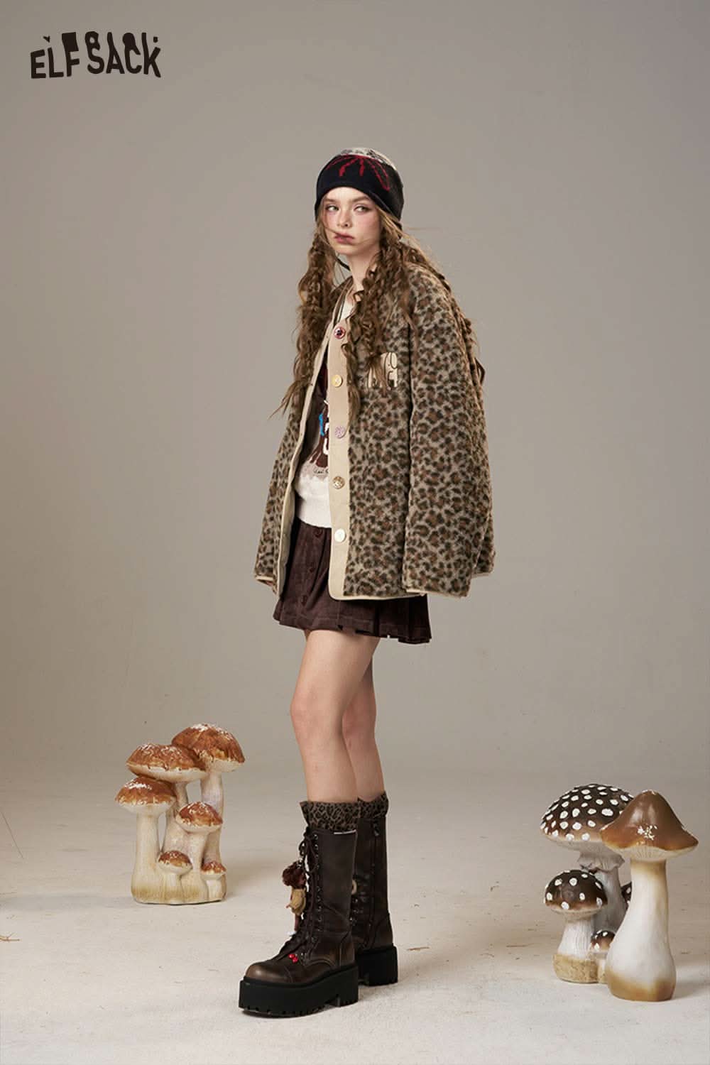 ELFSACK animal print faux shearling jacket styled with a skirt and beanie in a studio setting
