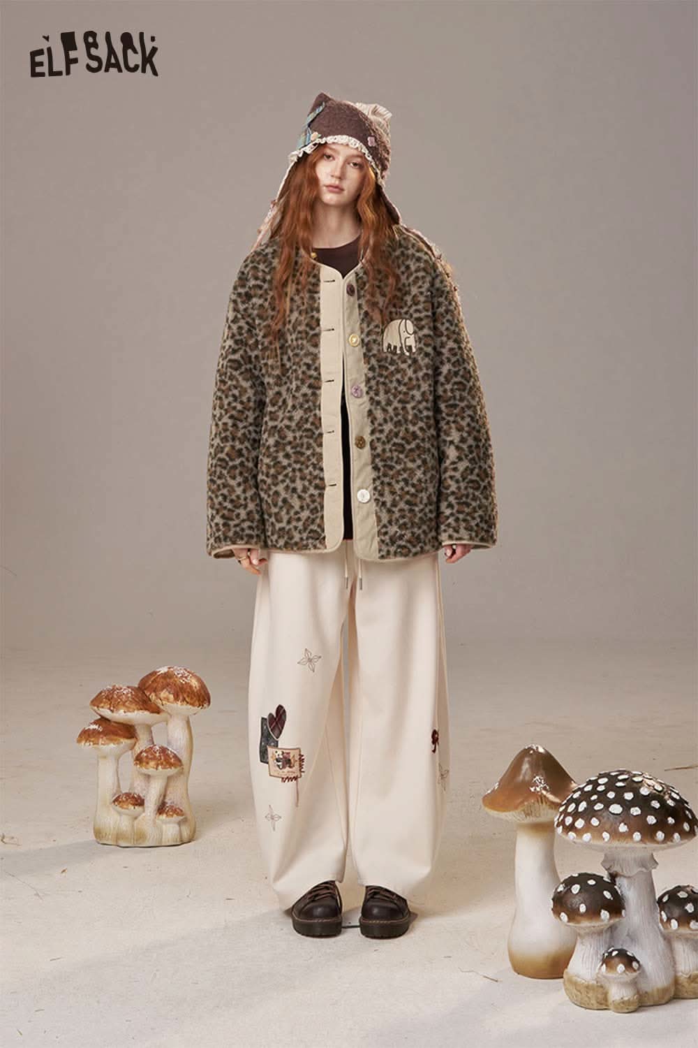 ELFSACK animal print faux shearling jacket displayed on a model with oversized pants and a playful hat