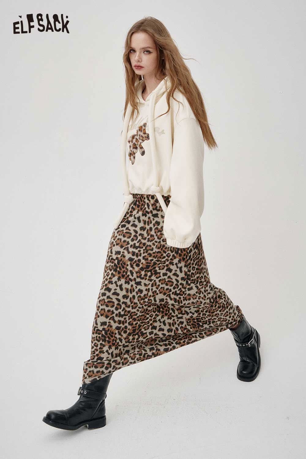 Stylish ELFSACK animal print maxi skirt with a flowy design, paired with a cozy white sweater