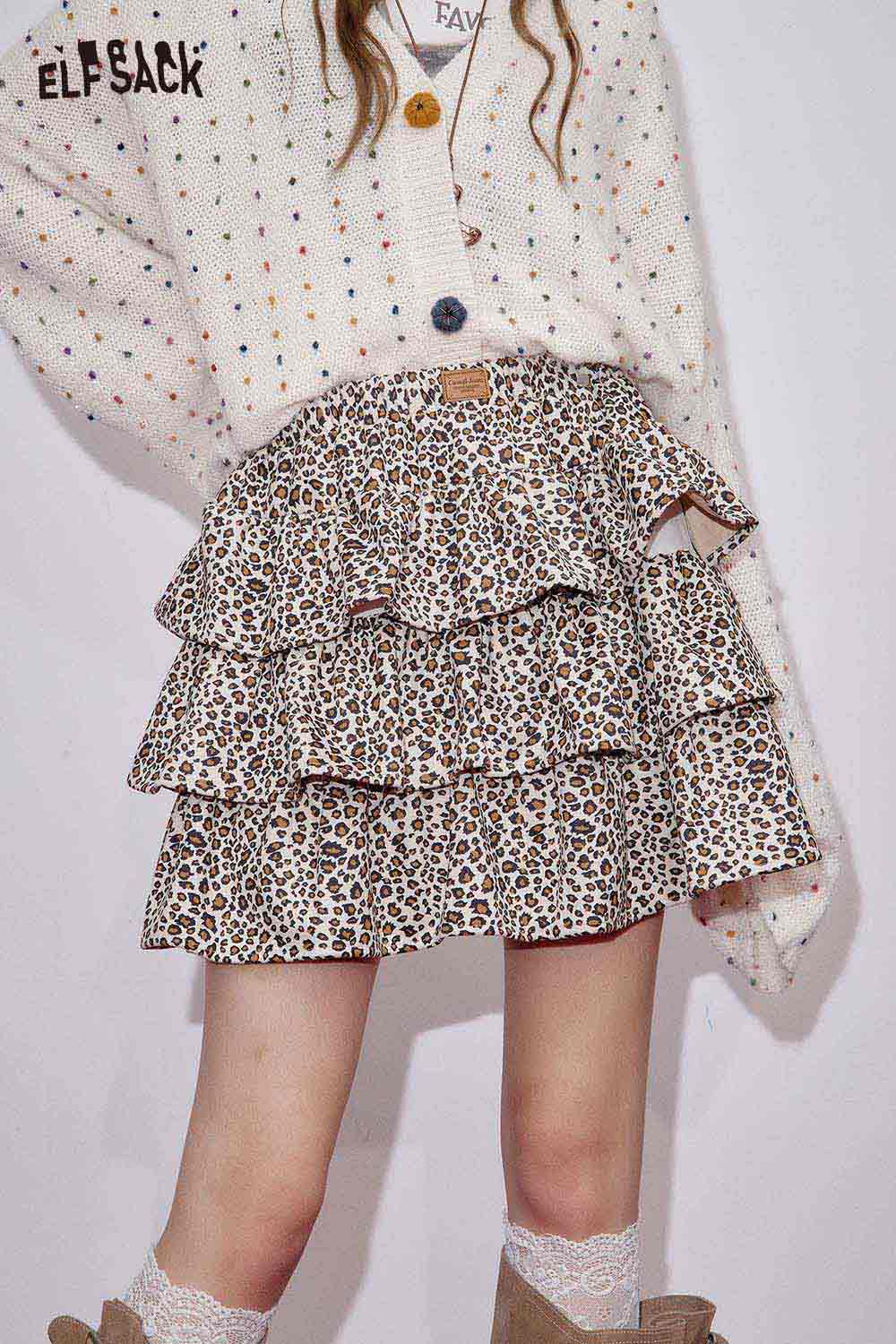 ELFSACK animal print pleated skirt with ruffled layers styled with a cozy sweater