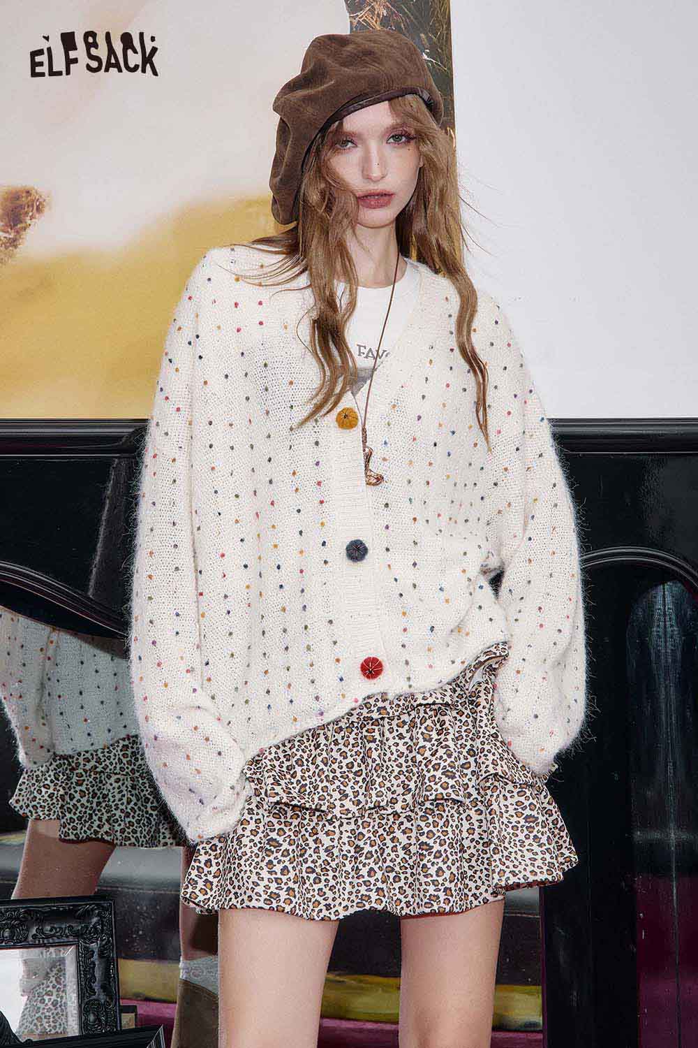 Trendy ELFSACK animal print pleated skirt styled with a cozy cardigan and hat for a chic look