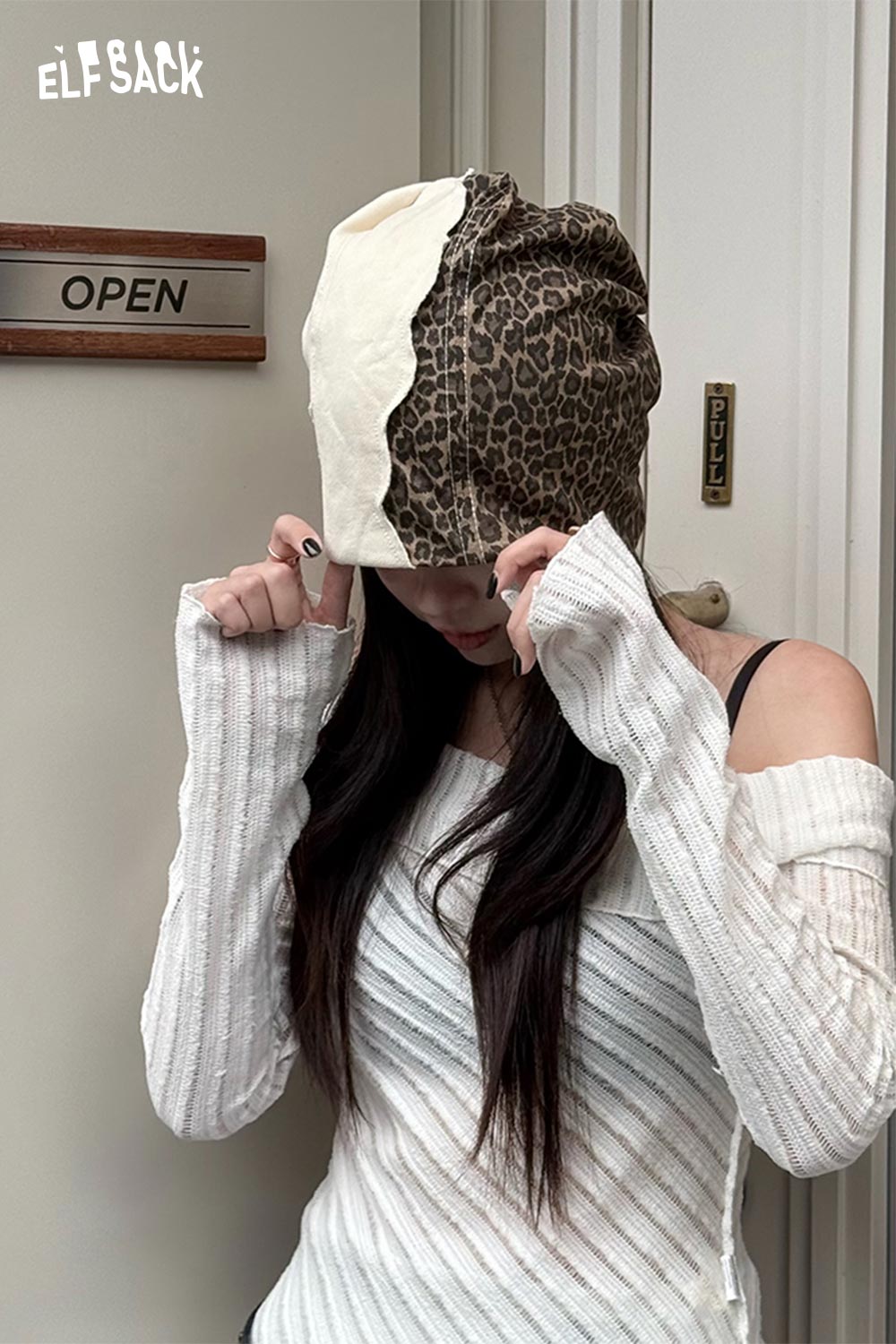 ELFSACK animal print slouchy beanie on model with white sweater, featuring a stylish design
