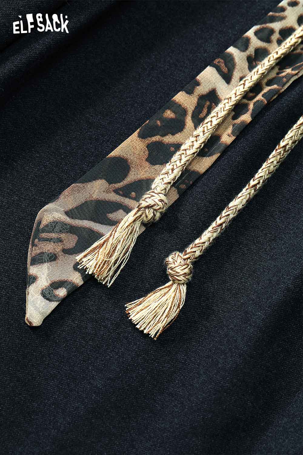 Close-up of ELFSACK animal print wide leg trousers showcasing braided ties and stylish detail
