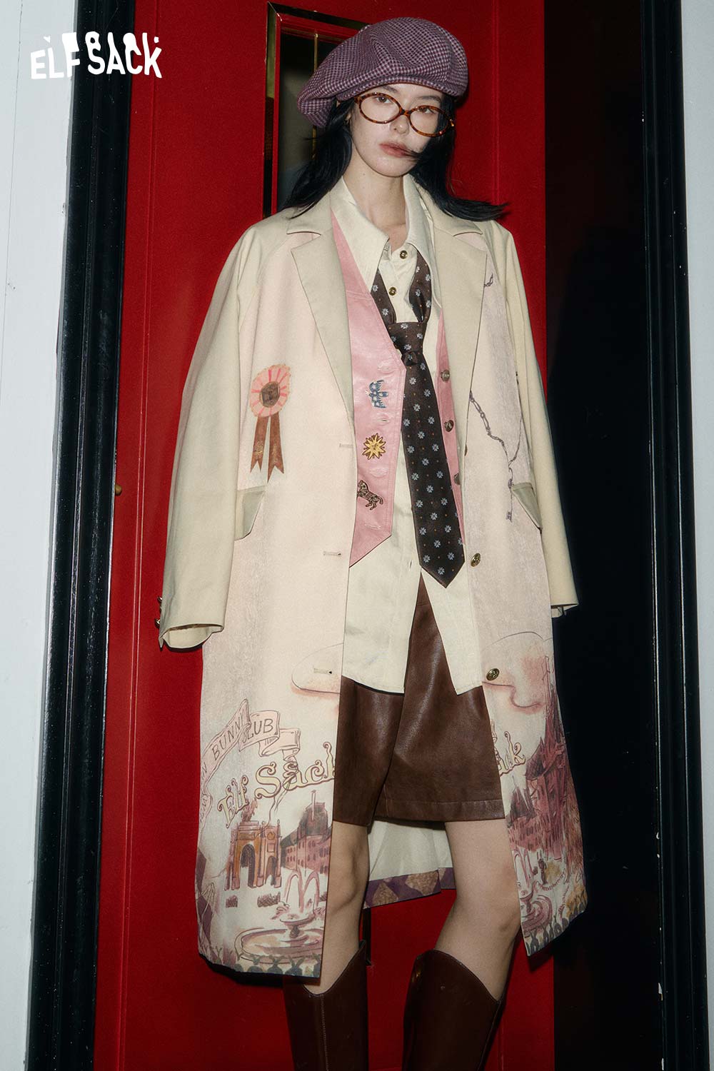 ELFSACK artistic print trench coat featuring unique graphics and a stylish design on a model