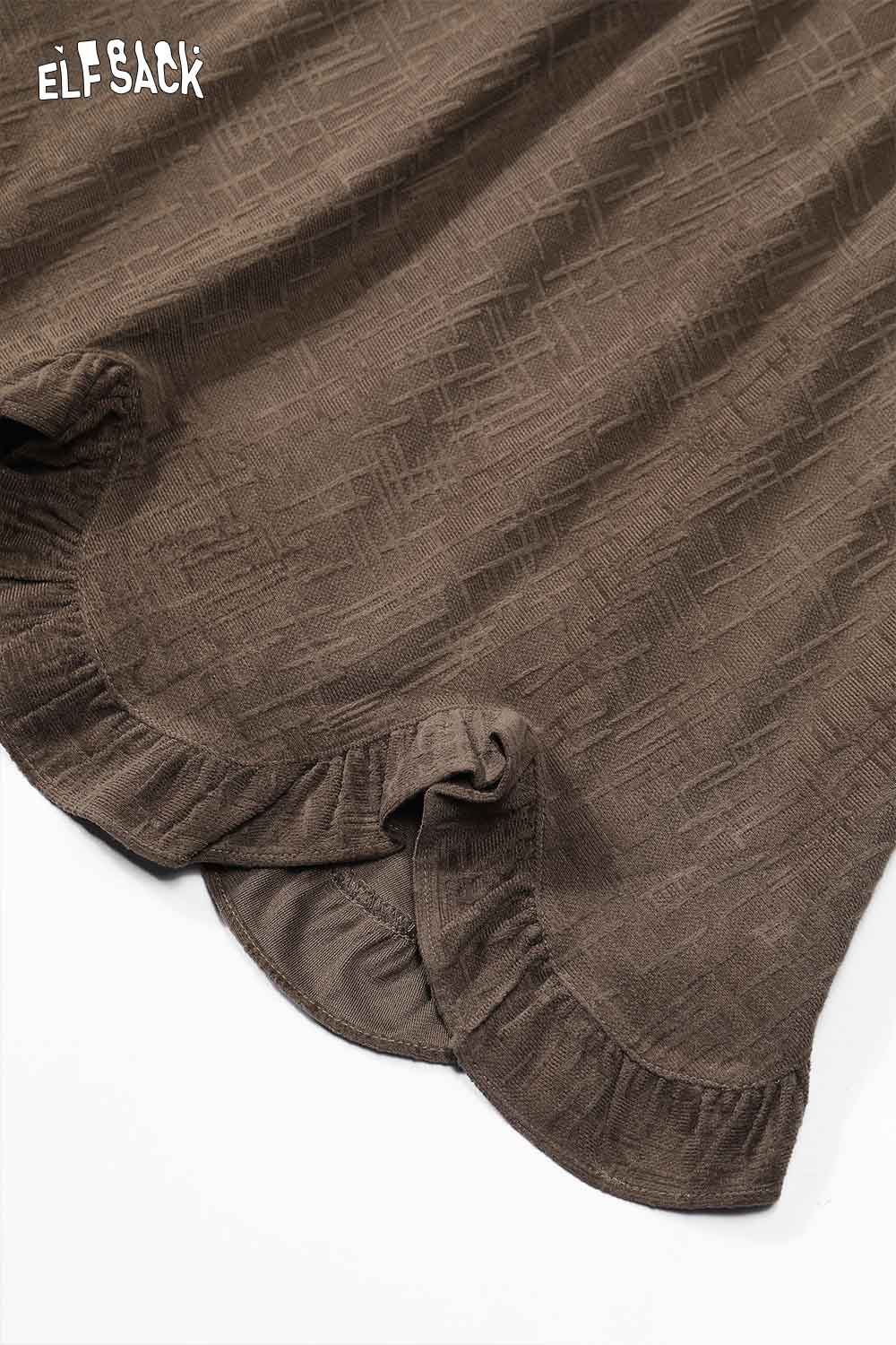 Close-up of ELFSACK asymmetric flounce hem skirt in earthy tone with textured fabric