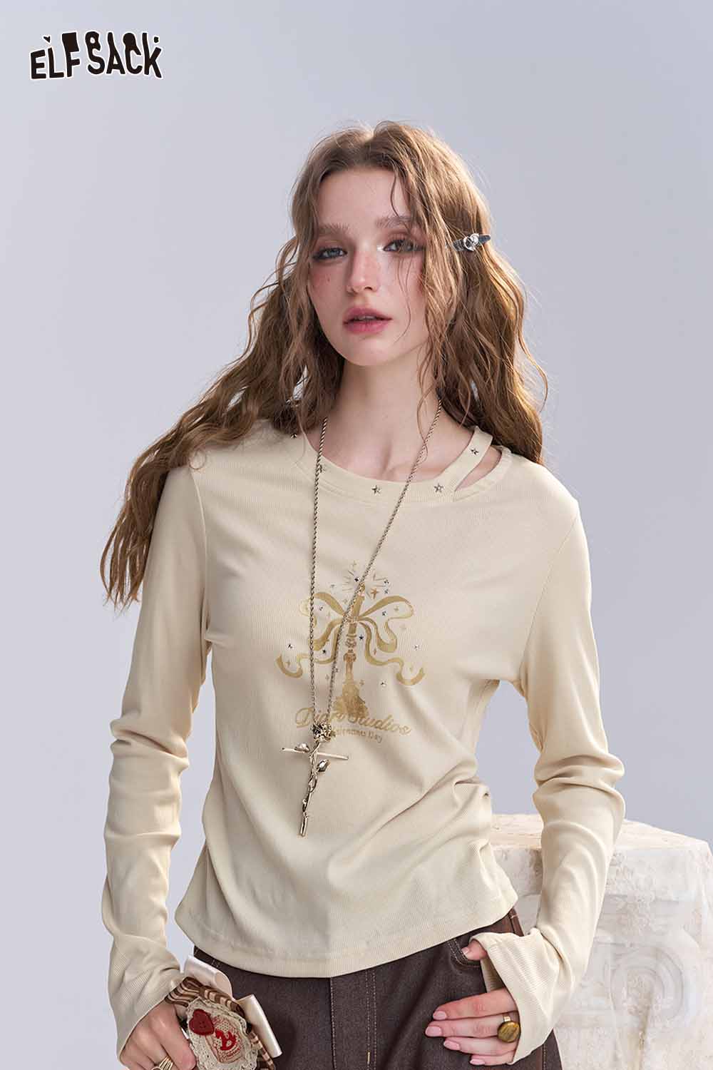 ELFSACK asymmetric neckline graphic tee in cream color featuring a stylish design and long sleeves