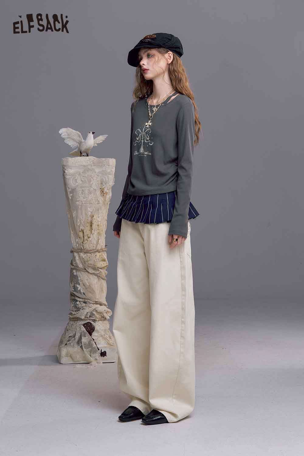 ELFSACK asymmetric neckline graphic tee in gray with unique design, styled with wide-leg pants