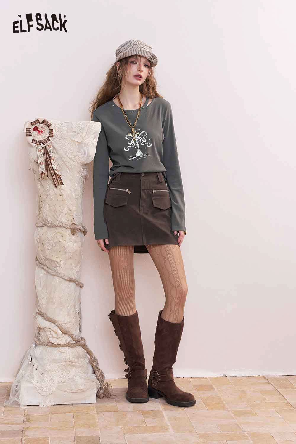 ELFSACK asymmetric neckline graphic tee in gray paired with a skirt and stylish boots