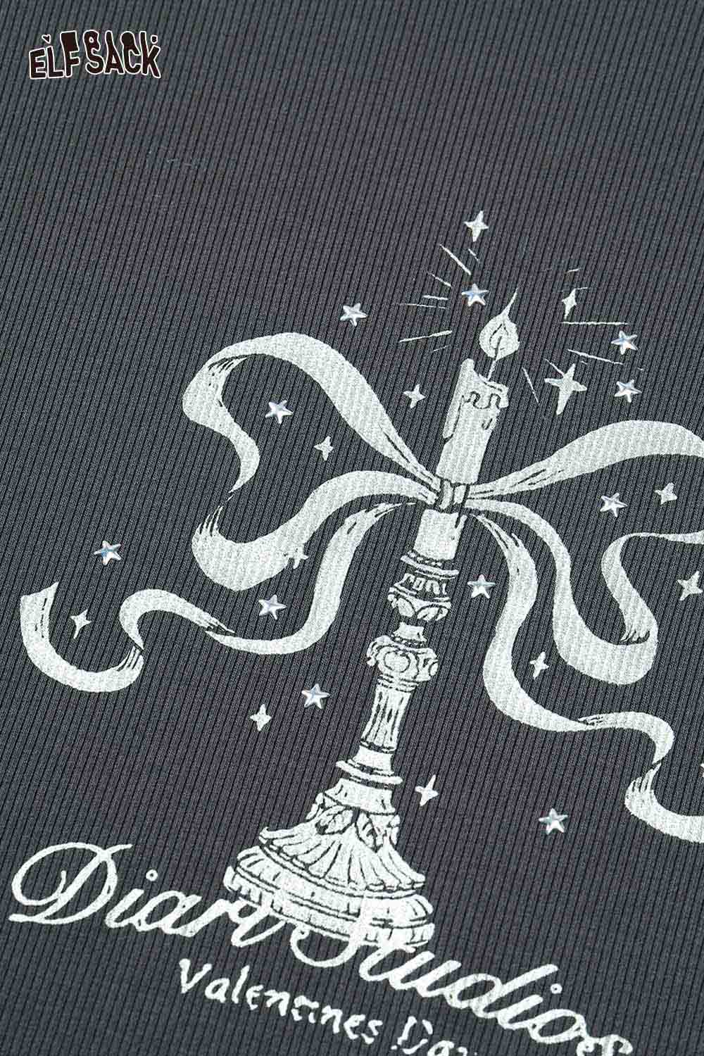 ELFSACK asymmetric neckline graphic tee featuring a candle design with a ribbon on a dark background