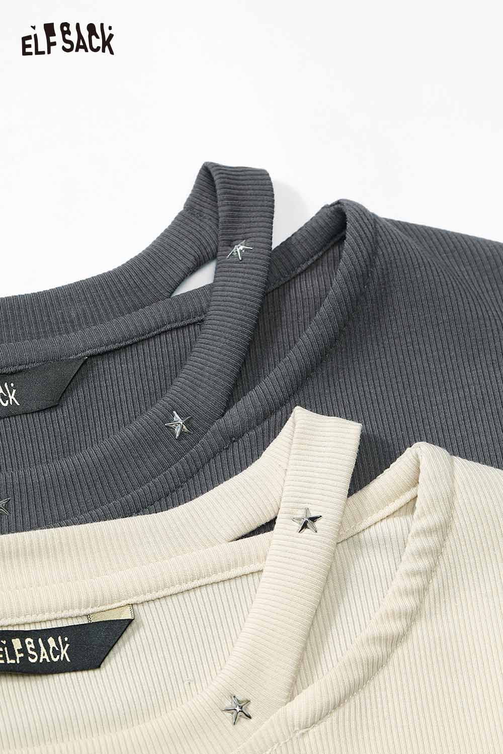 Two ELFSACK asymmetric neckline graphic tees in gray and beige with star accents