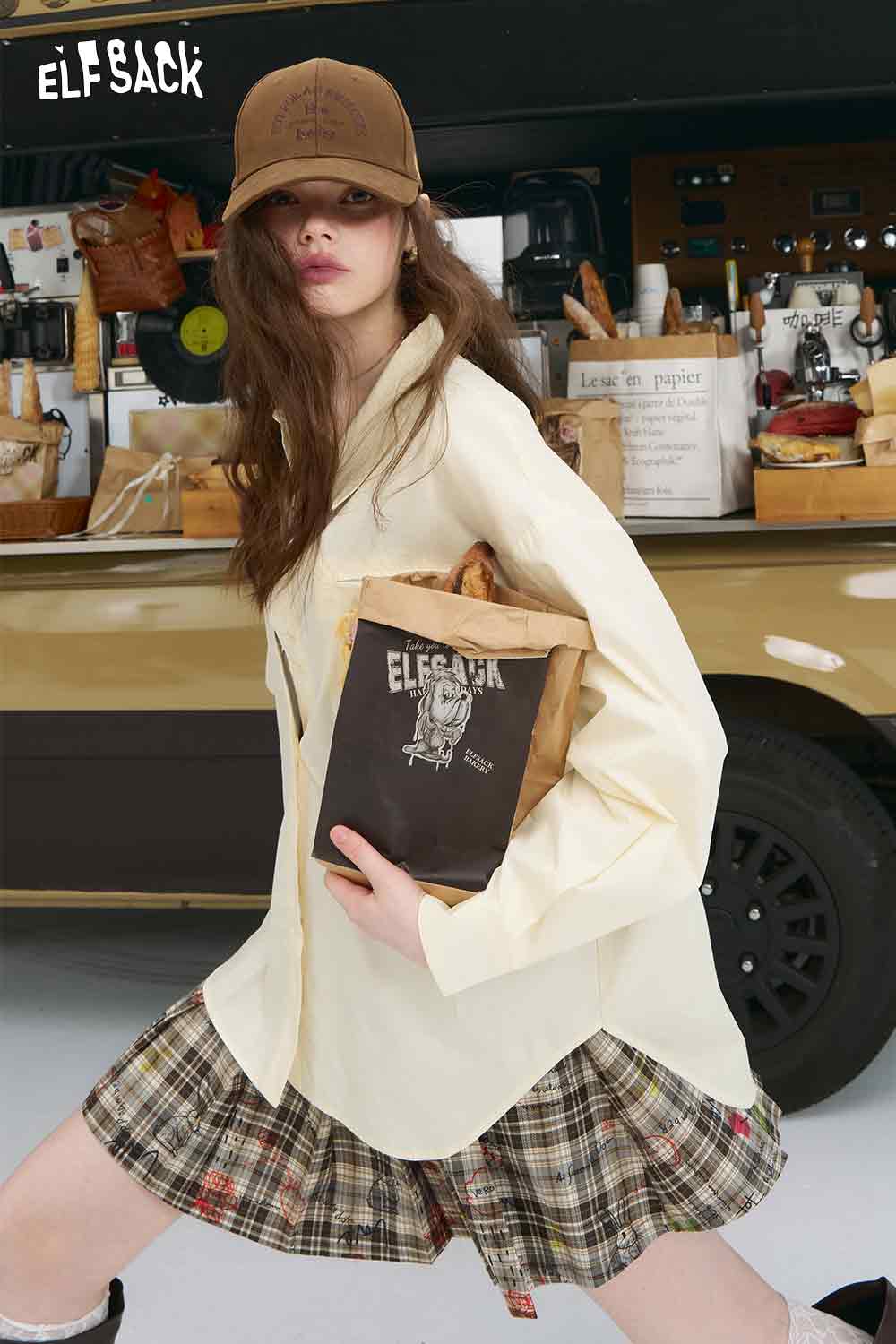 ELFSACK cream oversized women shirt with 3D handmade crocheted shirt accents worn with plaid skirt and cap