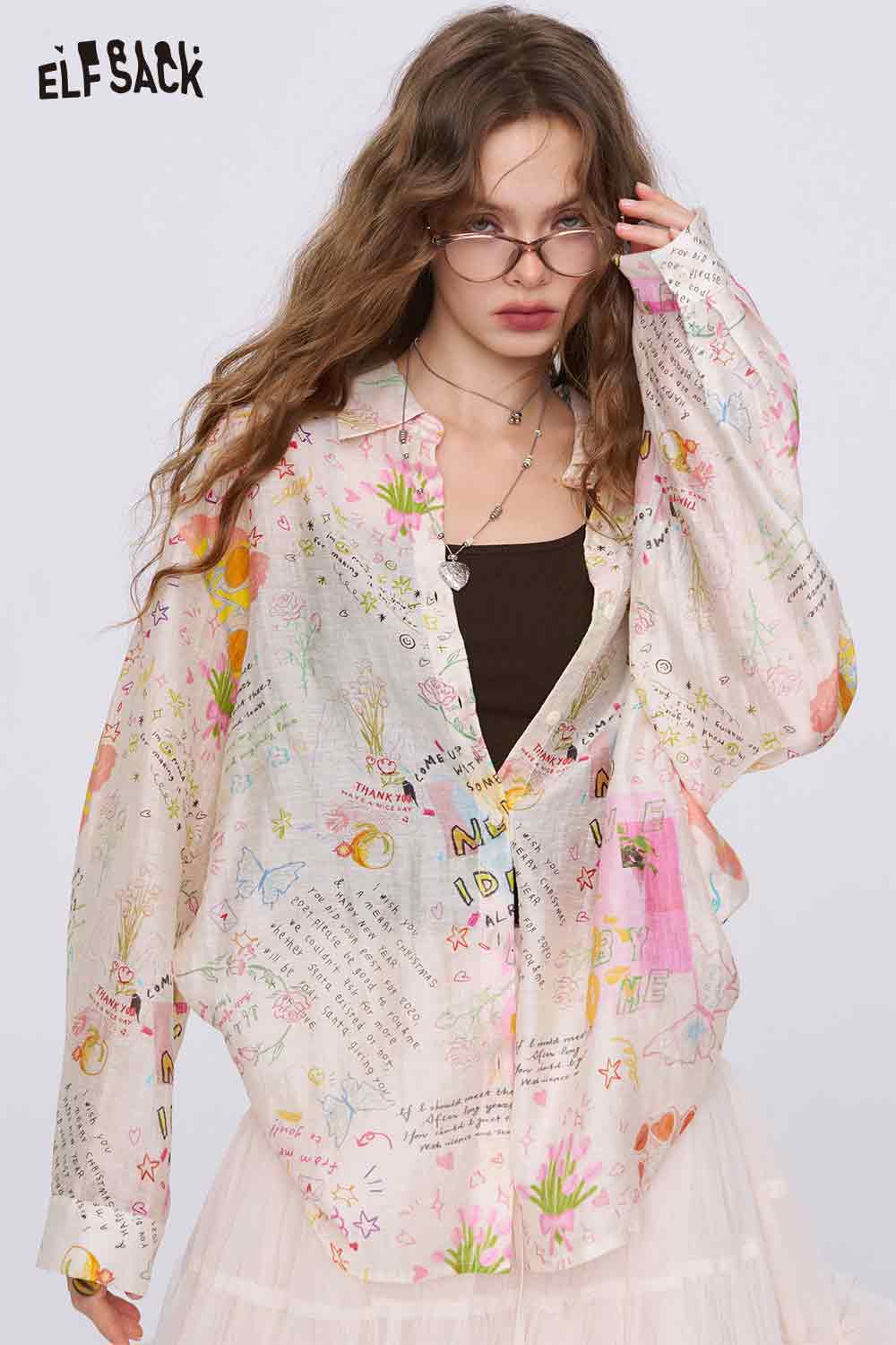 ELFSACK oversized pastel sheer graffiti cartoon print shirt for women styled with black camisole