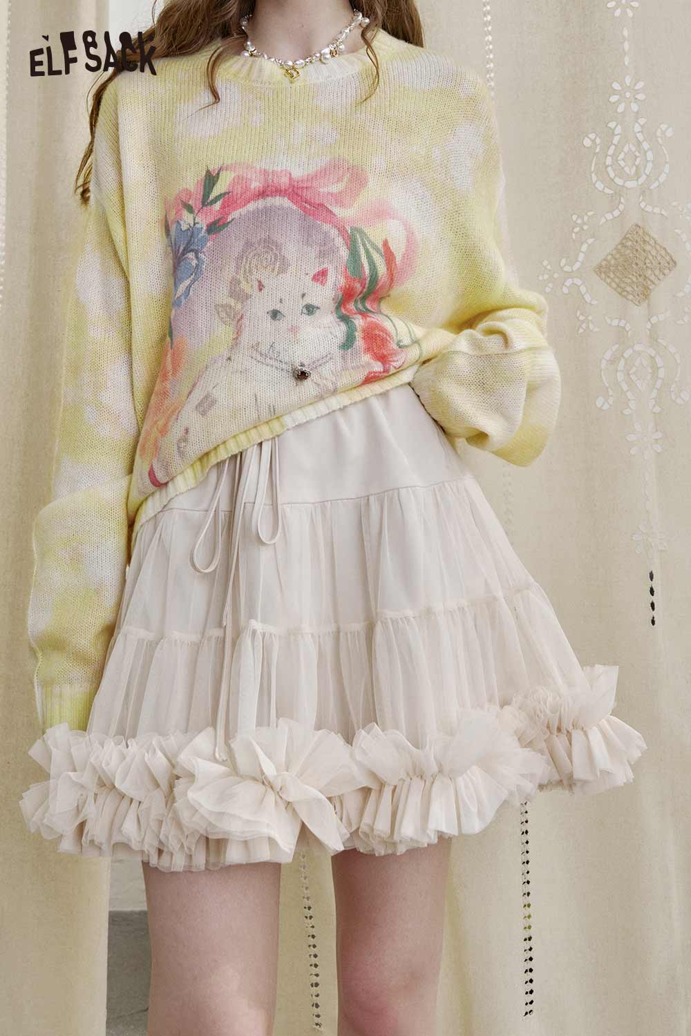ELFSACK ballerina style tulle skirt with ruffled hem paired with a colorful graphic sweater