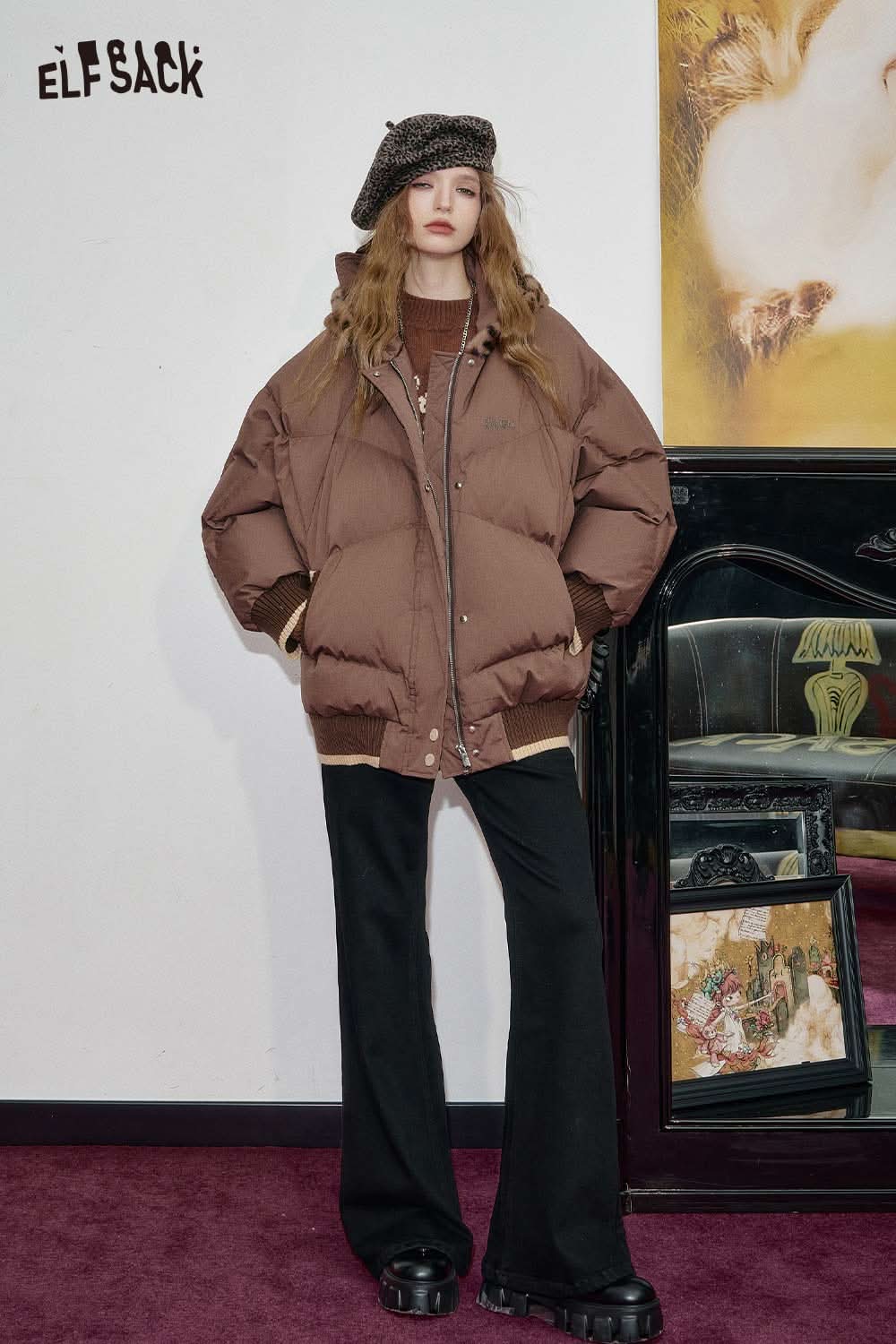 Brown oversized puffer jacket layered over a bear embroidery knit top for a stylish winter look