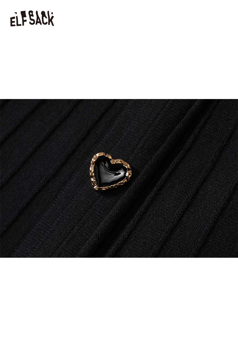 Close-up of ELFSACK black knit sheath dress featuring a heart-shaped embellishment on the fabric