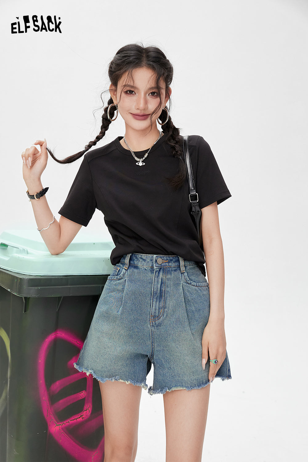 ELFSACK black BM Style T-shirt worn with denim shorts and accessories on model