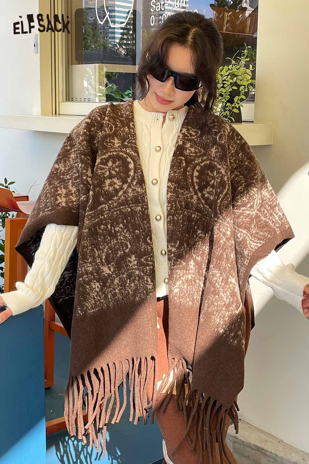 ELFSACK bohemian knit shawl with fringe in brown, styled with a cozy button-up sweater