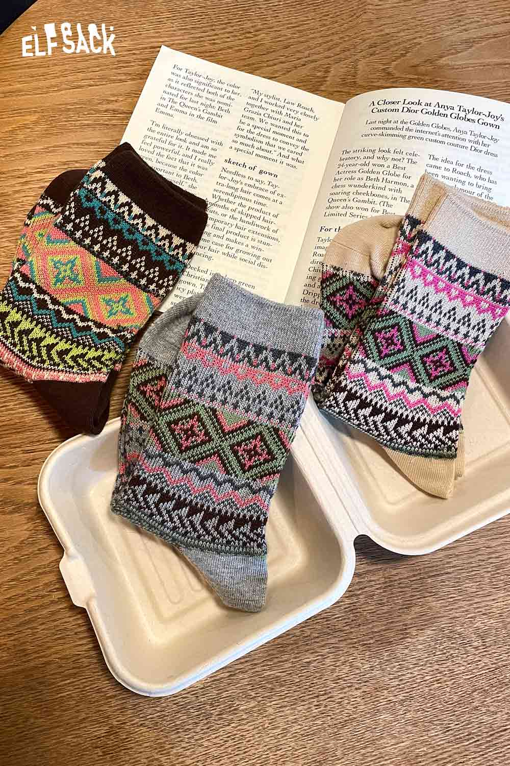 
                  
                    Colorful ELFSACK bohemian stripe socks for women displayed on a book and container
                  
                