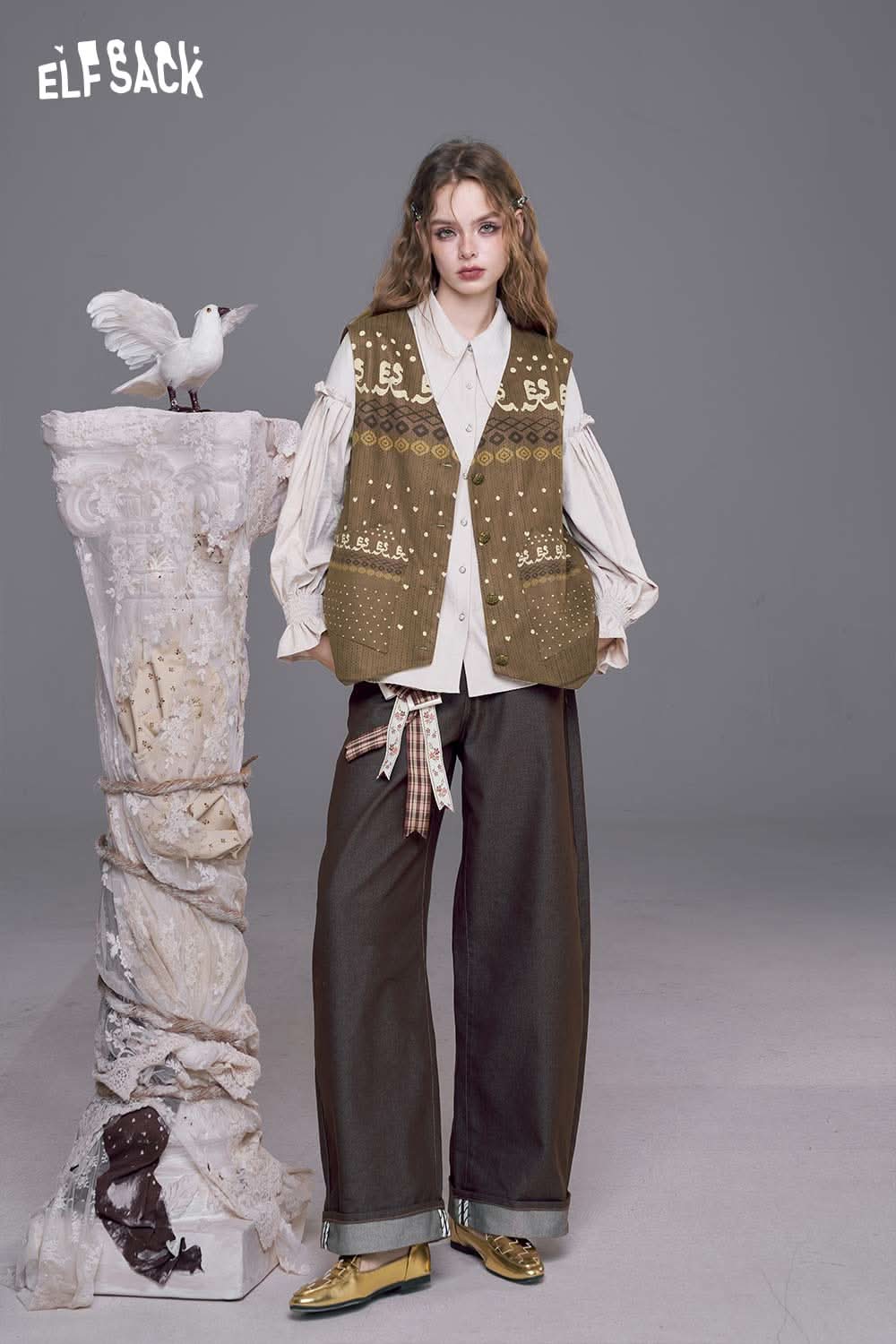 ELFSACK bohemian suede vest for women styled over a cream blouse and wide-leg pants