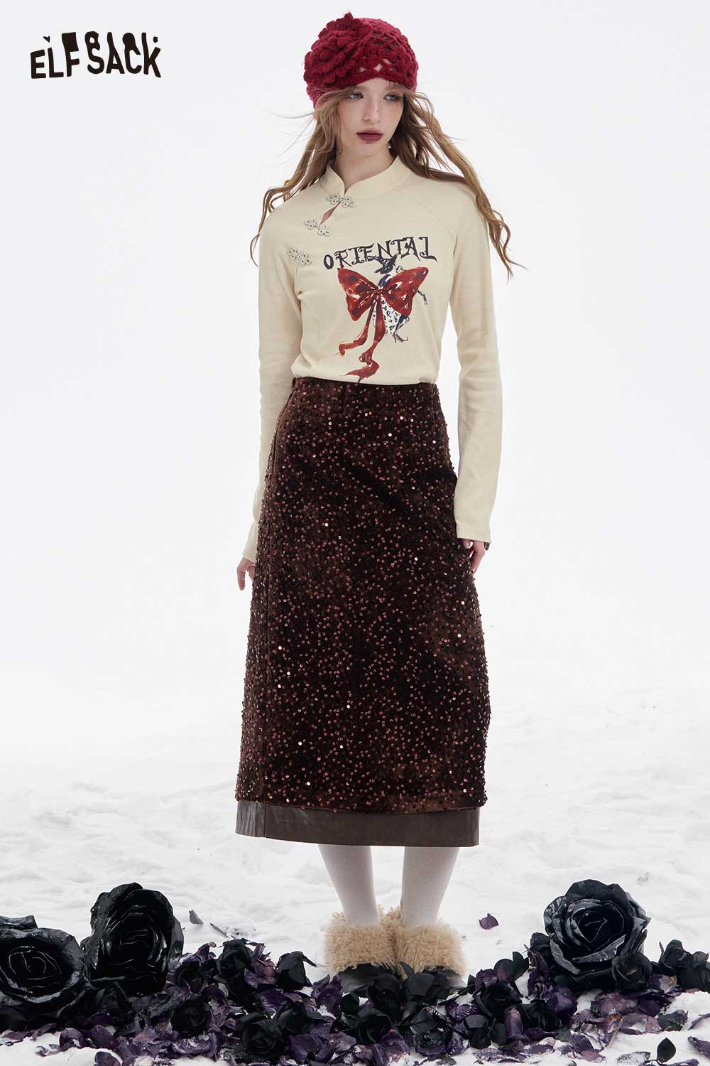 ELFSACK bow graphic long sleeve tshirt styled with a brown skirt in a floral setting