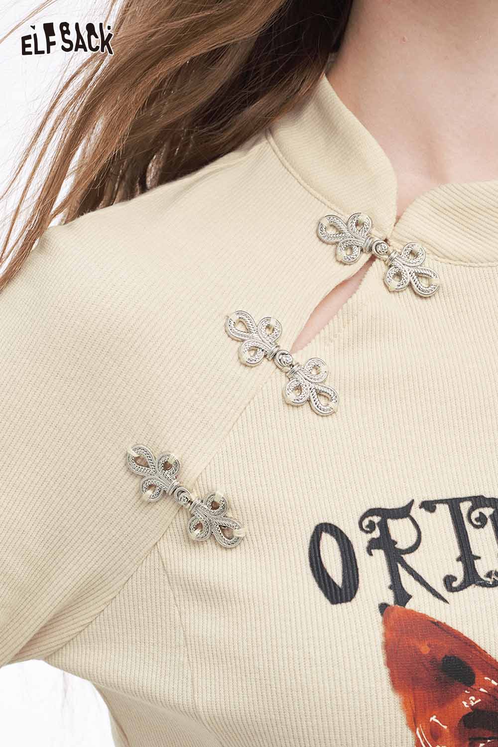 ELFSACK bow graphic long sleeve tshirt in beige with decorative bow accents and unique collar design