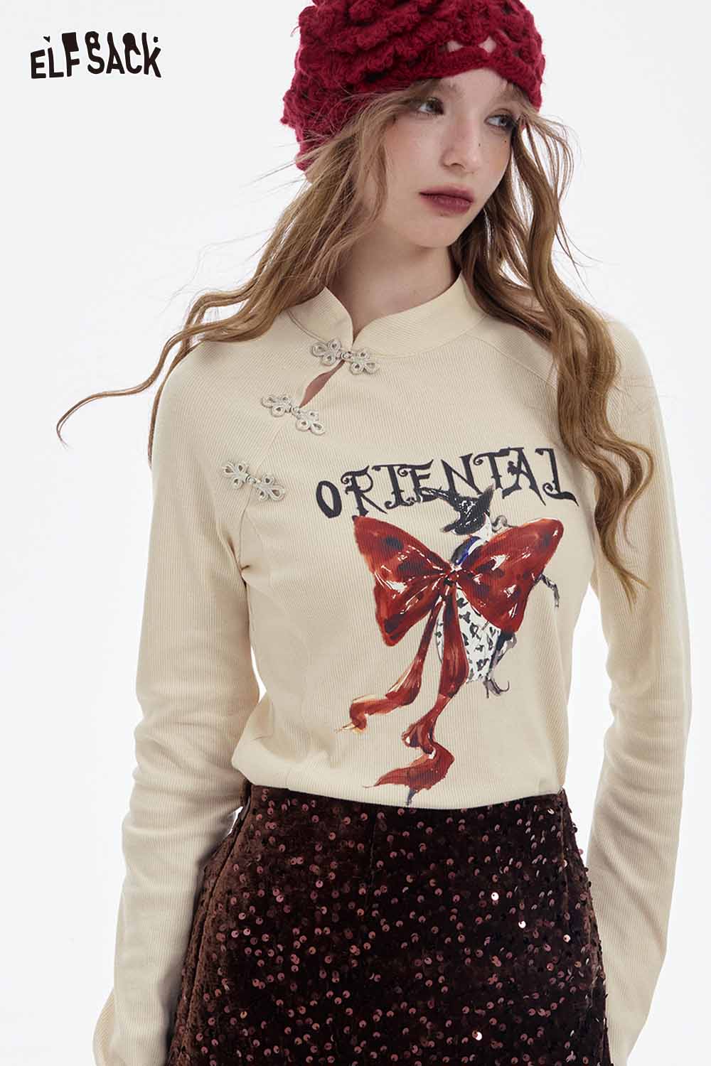 ELFSACK bow graphic long sleeve tshirt featuring a stylish design with a bow and decorative details