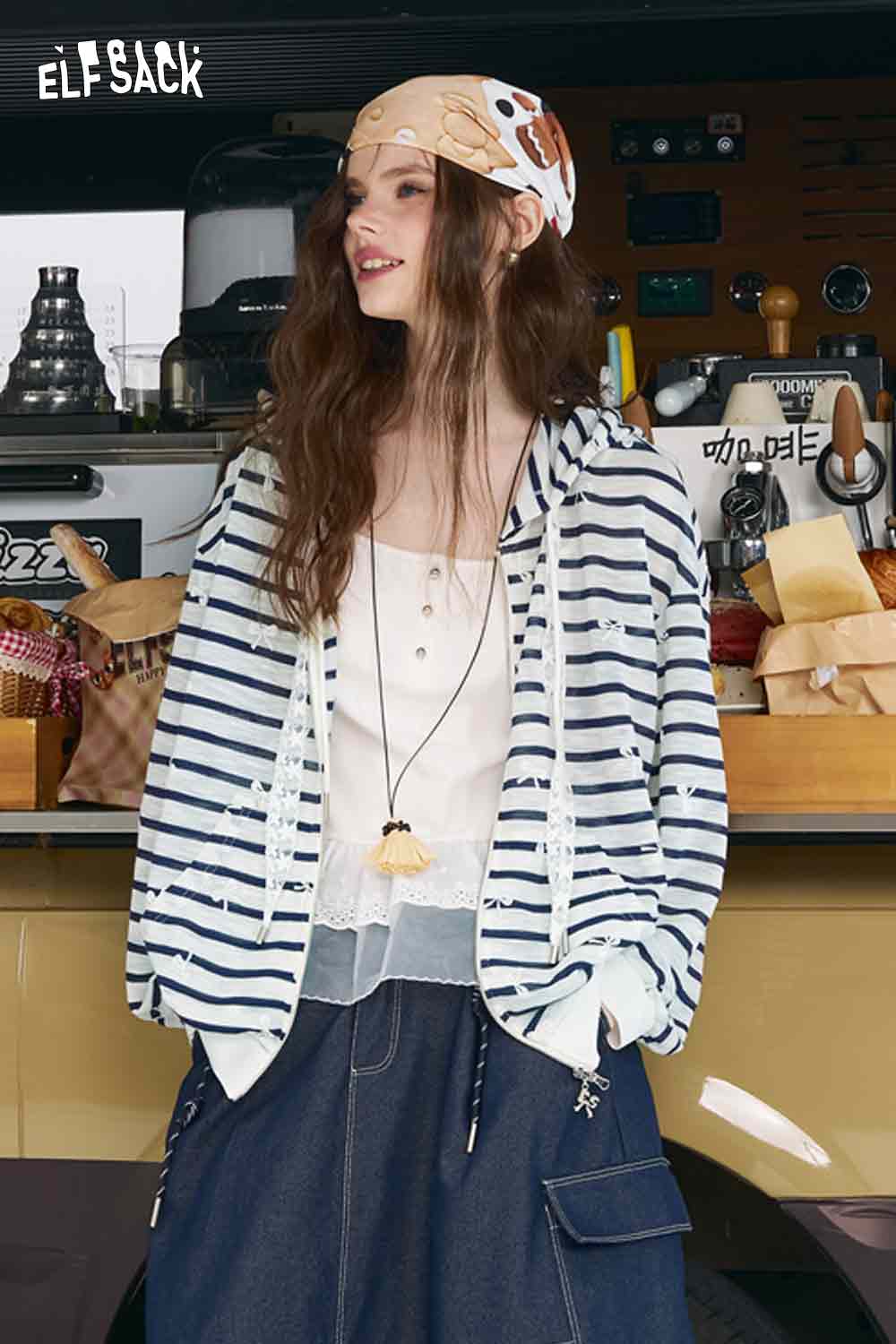 ELFSACK model wearing oversized striped cardigan for women in navy and white with hood over camisole and cargo skirt