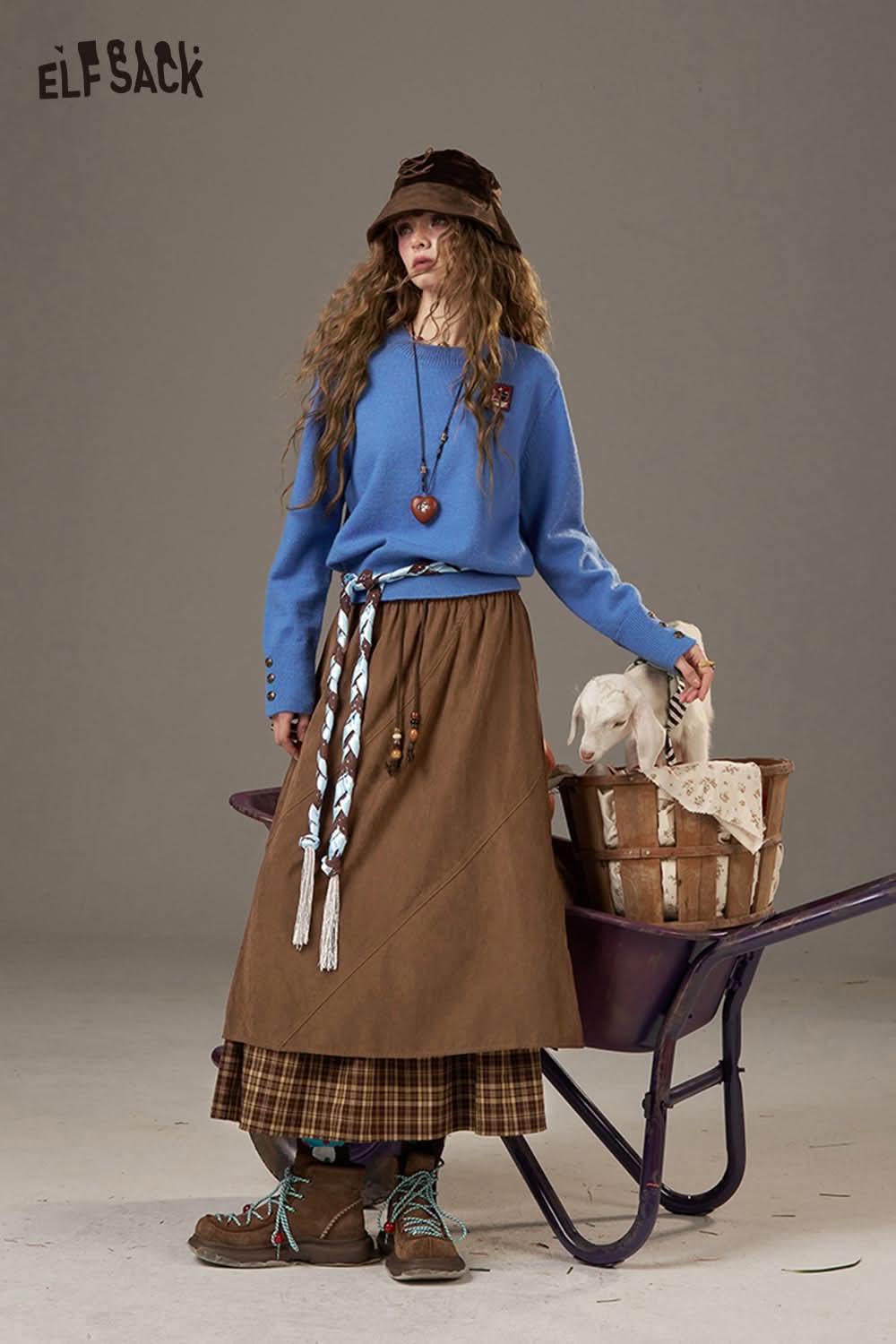 ELFSACK breathable lace patchwork skirt paired with a blue sweater and stylish accessories