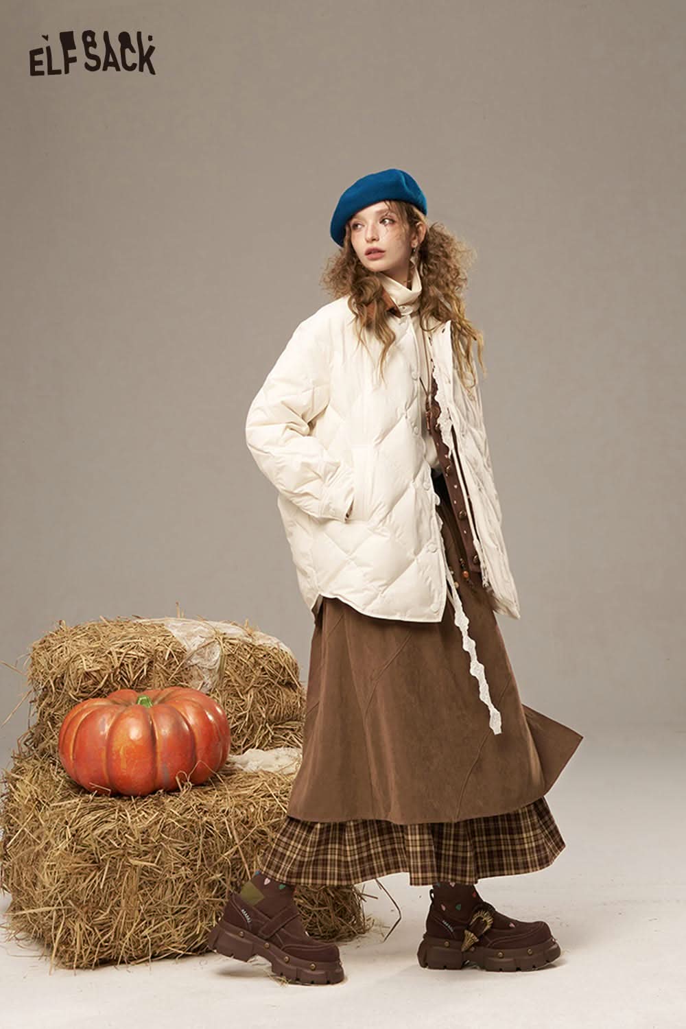Model wearing a breathable lace patchwork skirt paired with a cozy white puffer jacket