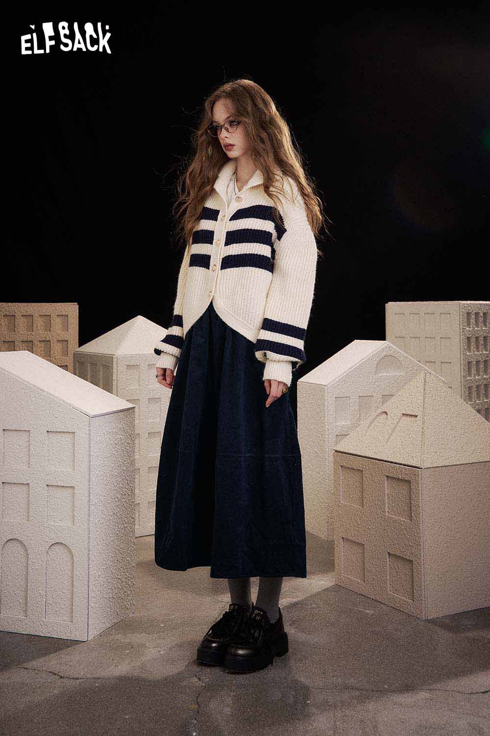 ELFSACK breathable midi skirt for women paired with a stylish sweater in a trendy urban setting