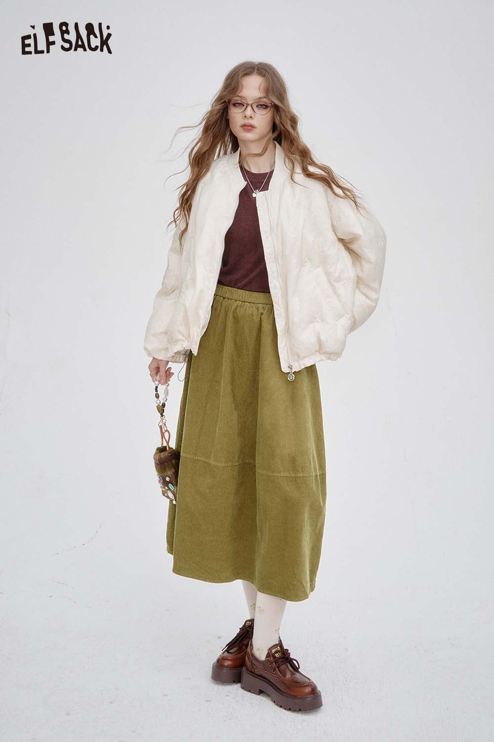 ELFSACK breathable midi skirt for women in olive green paired with a stylish white bomber jacket