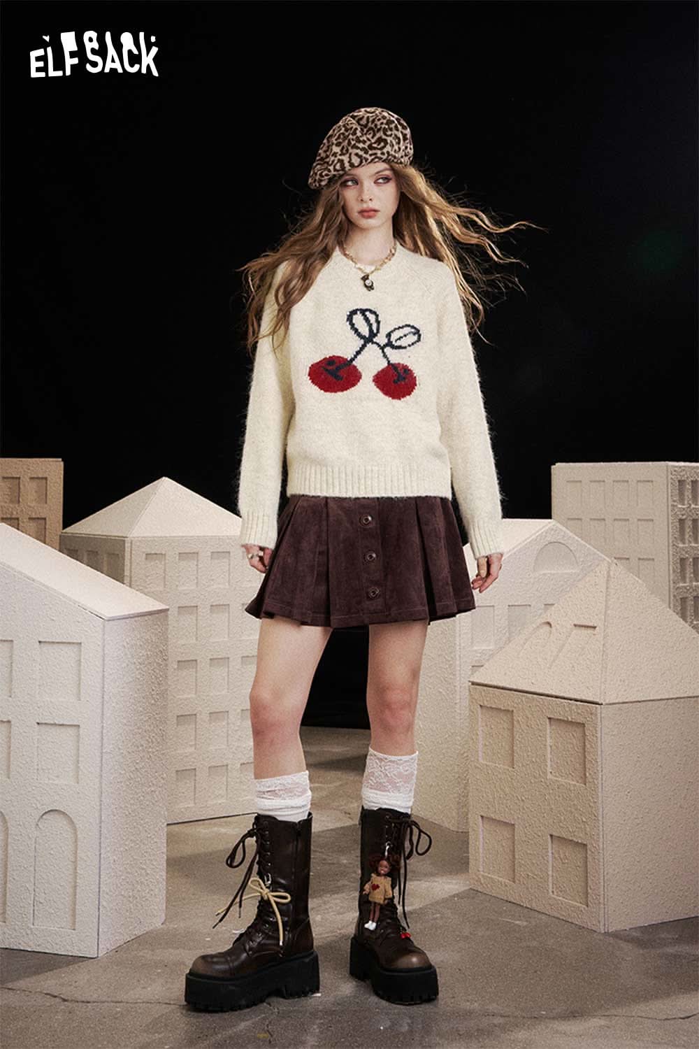 ELFSACK cartoon cherry print sweater in cream with colorful cherry design, paired with a brown skirt