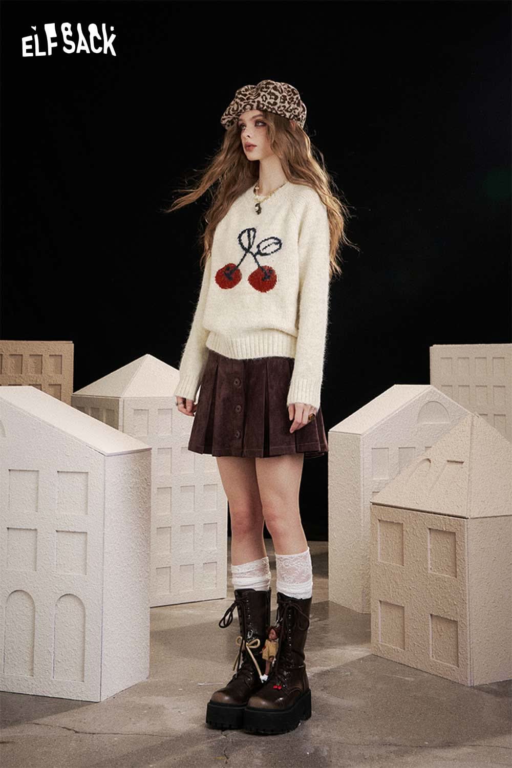 ELFSACK cartoon cherry print sweater in cream with unique design and colorful details, styled with a skirt and boots