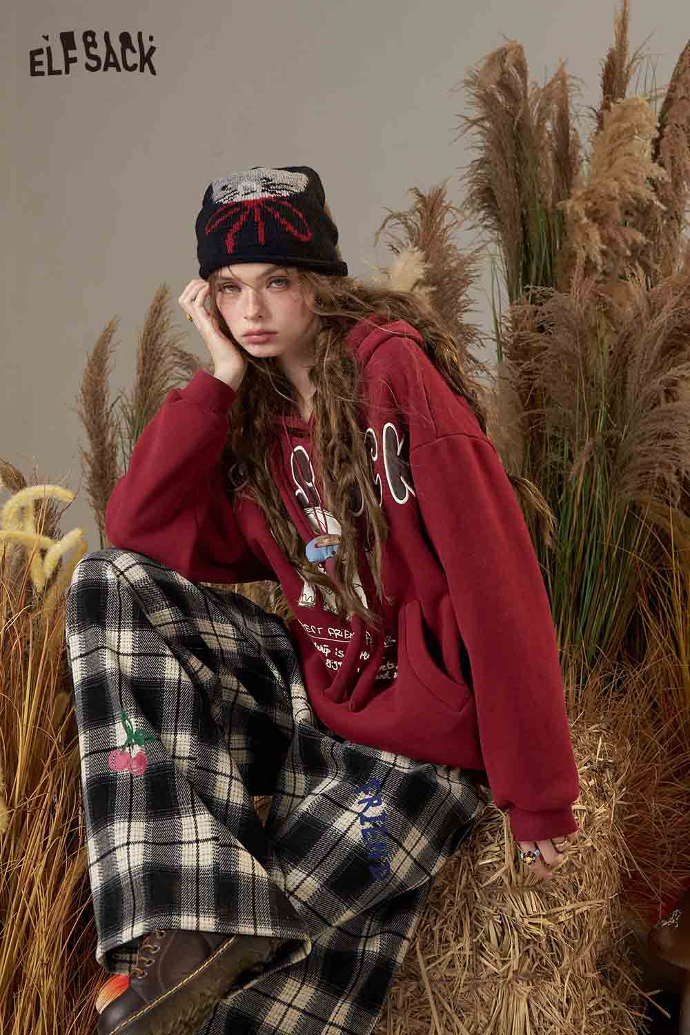 ELFSACK cartoon elephant hooded sweatshirt in burgundy worn with plaid pants, styled for a casual look